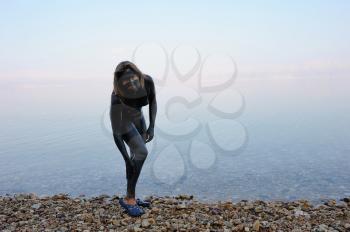 Woman daubed themselves therapeutic mud on the shore of the Dead Sea