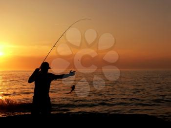 Royalty Free Photo of an Angler at Dusk