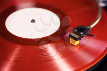 Vintage Stereo Turntable Plays Red Vinyl Record Album, Tonearm with Headshell Closeup 