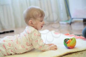 baby girl playing with smile expression indoors