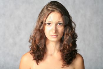 portrait of sexy brunette on grey background