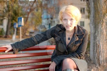 Beautiful girl on a park bench alone