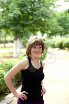 The young smiling woman in the park.