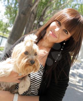 Fashion portrait of beautiful woman with small dog