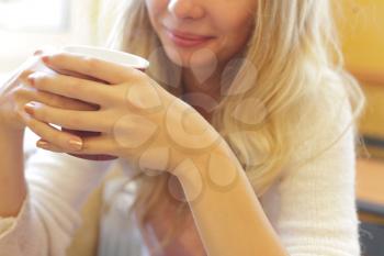 The young beautiful girl with a cup headshot