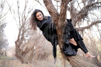 Shot of a gothic woman in a autumn park. Halloween.