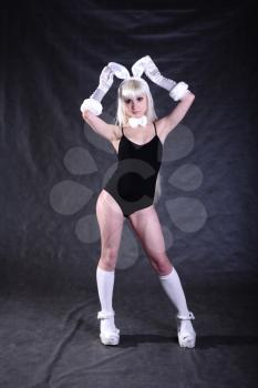 A bunny dressed girl  studio shooting on gray background