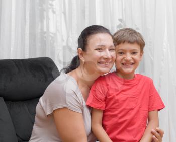 Happy mom and son hugging and laughing