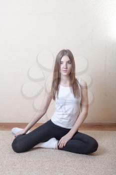 Pretty blonde women meditating in yoga studio on beige background . Mental health spiritual development concept