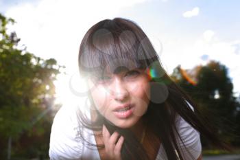 face outdoor portrait of young beautiful tender girl lightened with sun backlit open mouth
