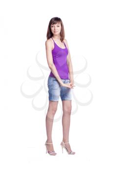 Full length portrait of a confident young female standing on white background