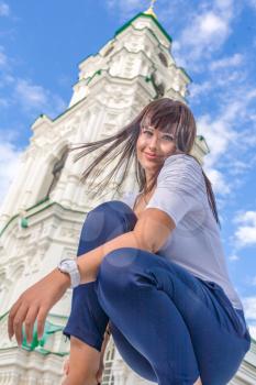 Model posing in front of tall historical building