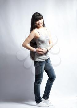 full length image of young beautiful casual college / university student. Gorgeous mixed race chinese / caucasian model. on white background.