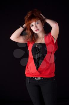 redhead girl torso shot on black background