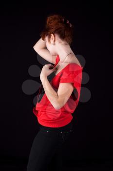 redhead girl torso shot on black background