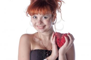 beautiful redhead caucasian girl with heart in hand on white background