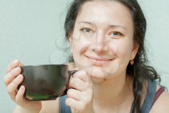 Close-up of a beautiful girl with a cup near the face