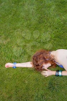 redhead slipping grass