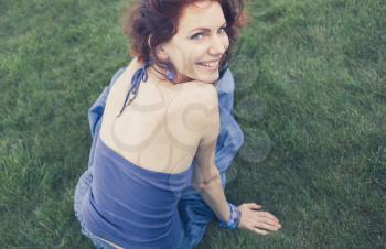 redhead smiling on grass, vintage looking photo shot