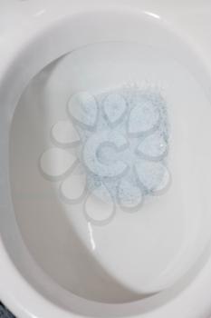 toilet bowl closeup with bubbles over water