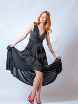 redhead full body in black dress,studio shot