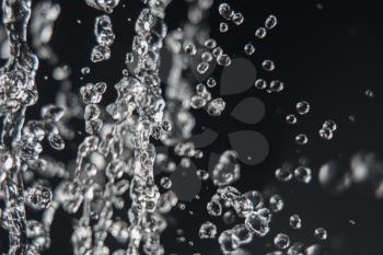 Levitation of water drops on black with copy space