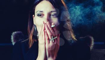 Young trendy woman smoking colorized toned image