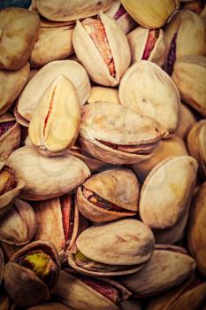 Pistachios macro image. Vertical image of fryed nuts organic food. Natural protein source.