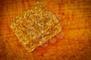 Brown sugar cube set on wooden background of cutting board