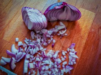 Fresh red onions on the cutting board cutted in small pieces