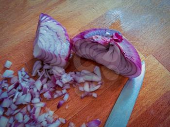 Shallot red onion on the cutting board cutted in small pieces andhals of the bulb, copyspace.