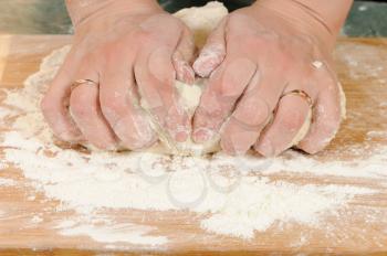 Royalty Free Photo of a Woman Kneading Dough