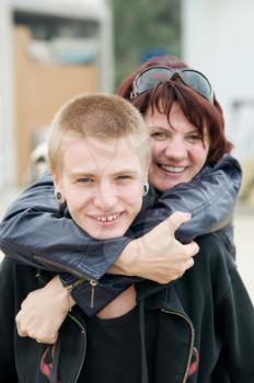 The happy mother and a son hugging and laughing