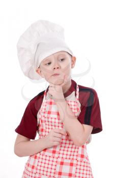 a pensive child chef isolated on white background