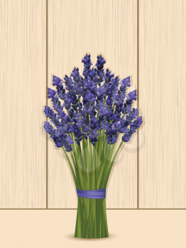 Lavender bunch tied with ribbon on a wooden background