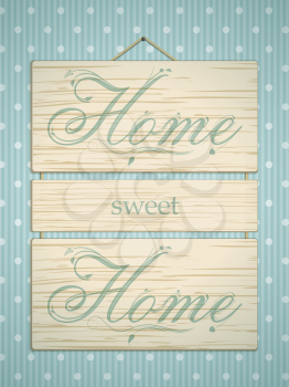 Wooden panel sign with 'home sweet home' message on blue polka dot