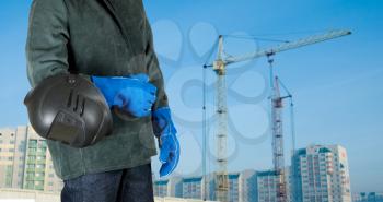 Royalty Free Photo of a Welder Standing In Front of a Building