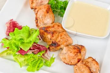 Royalty Free Photo of a Grilled Chicken Kebab With Sauce