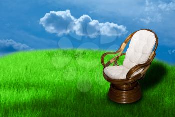 Royalty Free Photo of a Rocking Chair in Grass