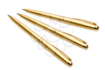 Gold pens on white background