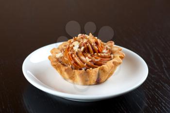 fresh baked cupcake with nuts on a wooden table