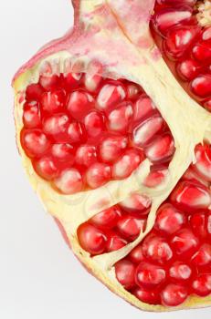 Half of pomegranate closeup on a white background