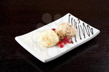 Dessert set of ice-cream with almond, chocolate and grapes