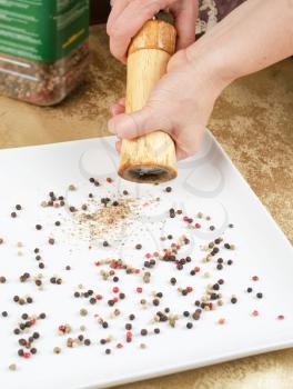 Female hands holding pepper mill