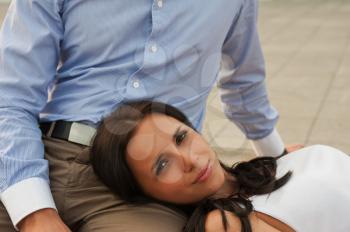 woman lying at mans knees at outdoor