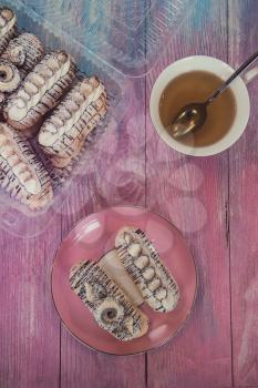 Cakes with tea on gradient color background