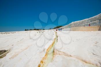 Pammukale, Turkey - July, 2015: tourists in Pammukale near modern turkey city Denizli. One of famous tourists place in Turkey.