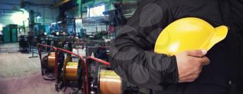 Worker with safety helmet at industrial factory