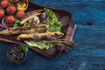 Grilled potato kebab on a blue wooden background