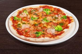 pizza with shrimp and broccoli at the table